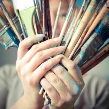 beautiful blonde woman painter in her studio